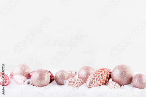 Christmas greeting card. Christmas tree branch on glitter golden bokeh lights background. New Year concept. Copy space.