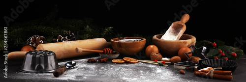 Baking ingredients for homemade pastry on wooden background with cookies and spieces