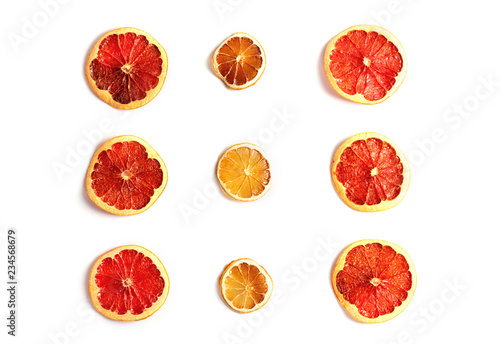 Set of dried slices of citrus isolated on white background. Top view, flat lay style.