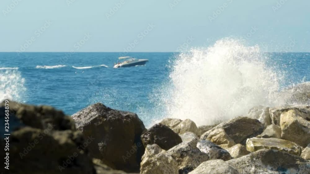 waves crashing on rocks and rocks, slow motion
