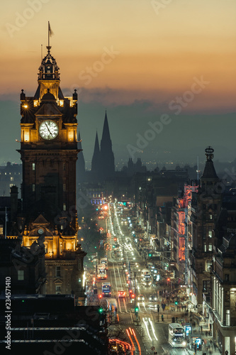 View of Princess Street, Edinburgh, from Calton Hill at dusk, with lights on and beautiful color in the sky. Scotland. Long exposure.