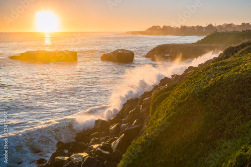 Waves crushing on the rocky shoreline at sunset  Santa Cruz  California