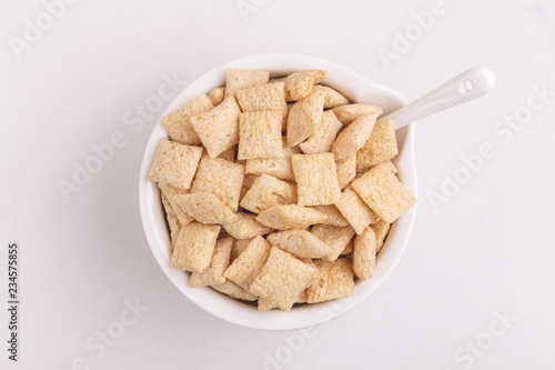 Corn pads in clay bowl on light white background