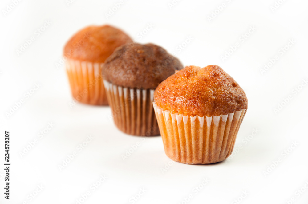 Close-up of lemon and chocolate muffins isolated on white background, selective focus.