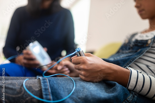 Fotografie Closeup of teenage girl holding zapper electrodes