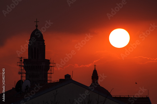 Church towers silhouette in stunning sunset 