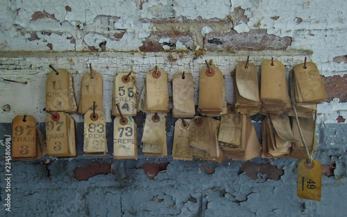 Numbered Tag on Peeling Paint Wall