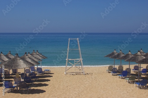 Watchtower of lifeguard inside sunbeds and umbrellas in a sandy beach in a sunny day at Vrachos Loutsa beach near Parga  Preveza  Greece