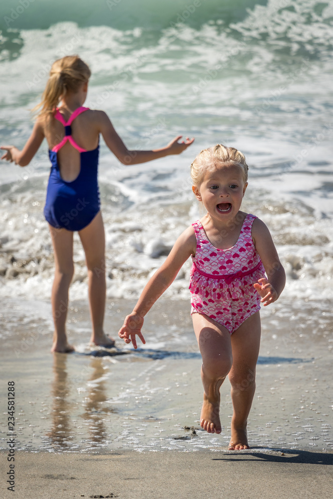 Little Girl Running Away From Ocean Waves and Screaming
