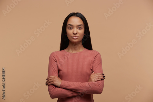 Canvas Print Portrait of calm, confident, attractive young mixed race brunette girl stands wi