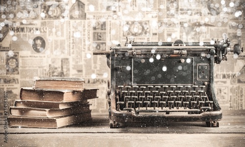 Old typewriter with books  on background