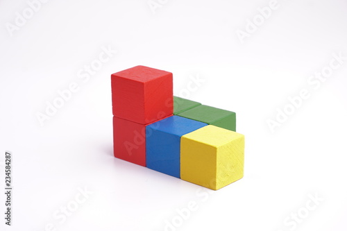 Colorful wooden cube isolated on white background.