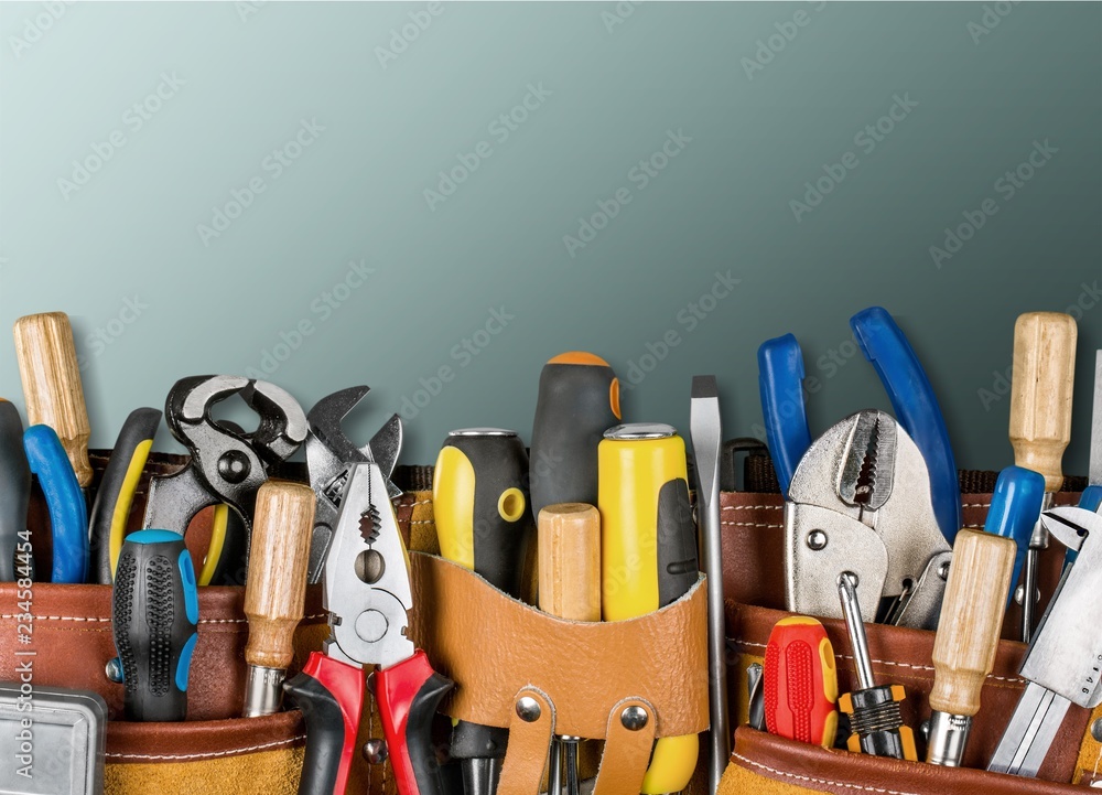 Tool belt with tools on wooden background Tool belt with tools on wooden background