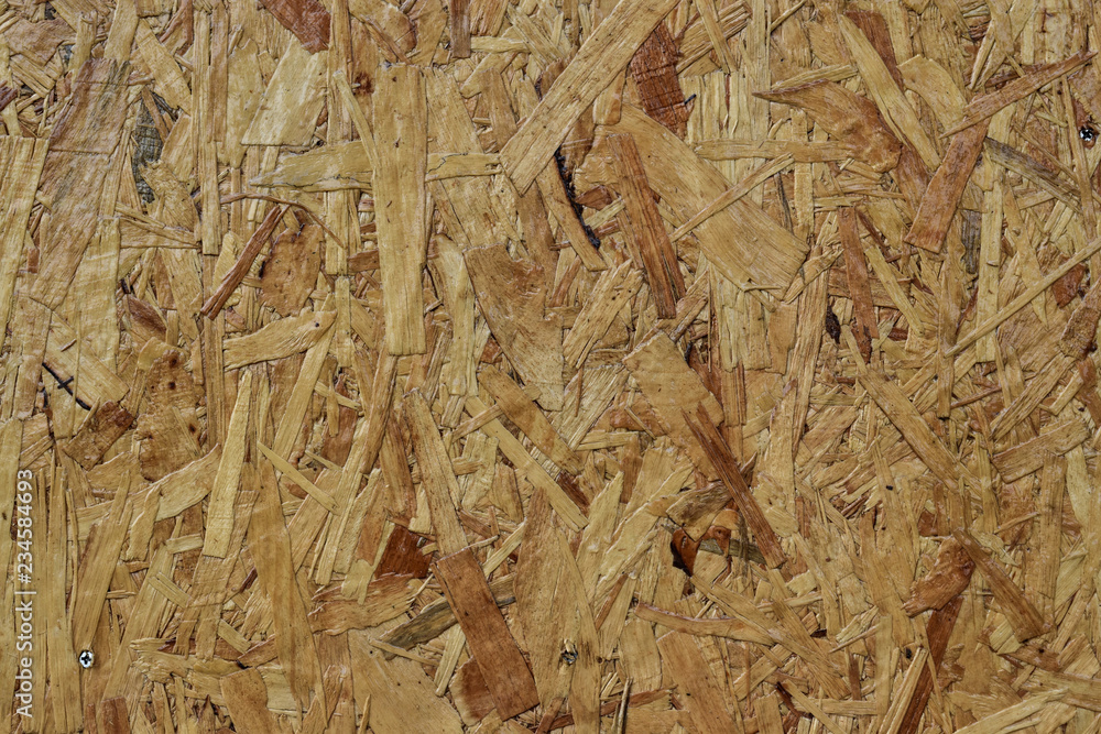 Sheet brown plywood with fragments of compressed sawdust. Sheet brown plywood with fragments of compressed sawdust.