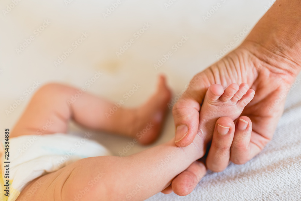 Mommy grabbing the little feet of her newborn daughter. Mommy grabbing the little feet of her newborn daughter.