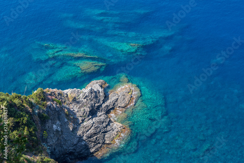 Crystal clear water and rocky shore of the Ligurian coastline  as seen from the Cinque Terre trail