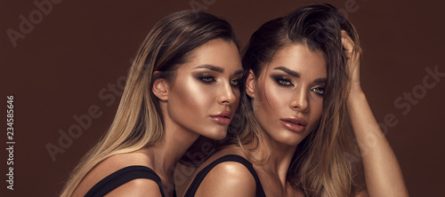 Two attractive twins women in glamour makeup photo