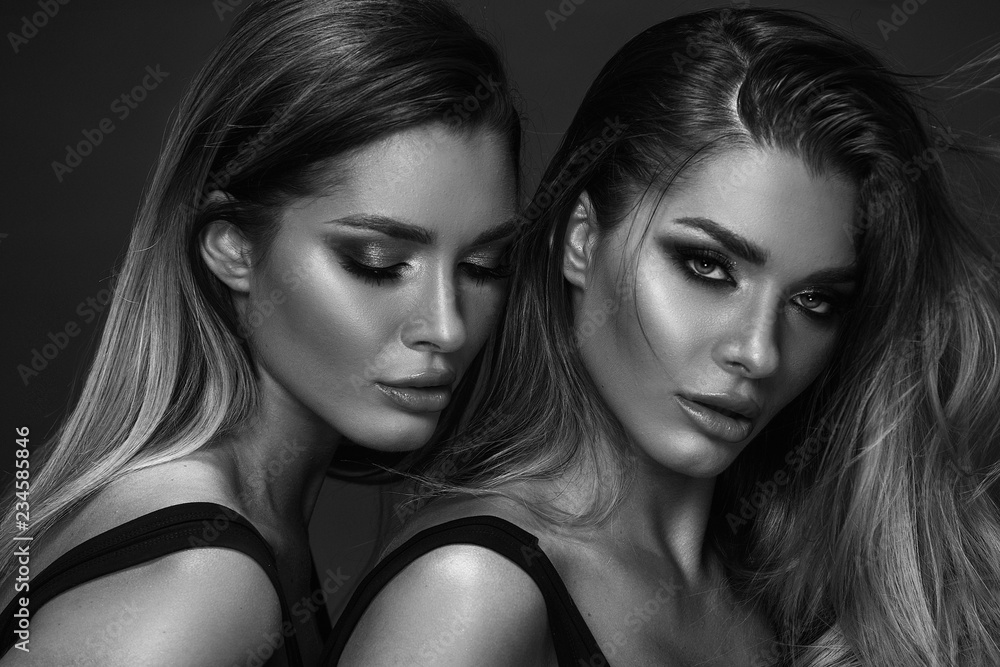 Fototapeta premium Two attractive twins women in glamour makeup