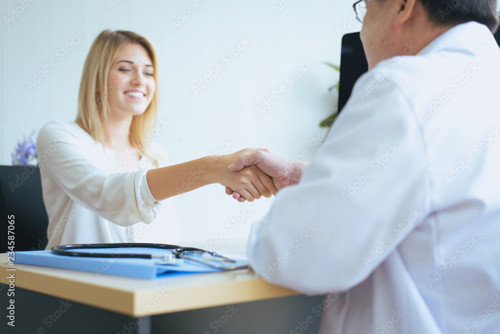 Handshake woman patient and man doctor reassuring consultation and encouragement Handshake woman patient and man doctor reassuring consultation and encouragement