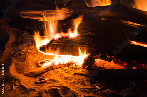night fire on the sand close-up