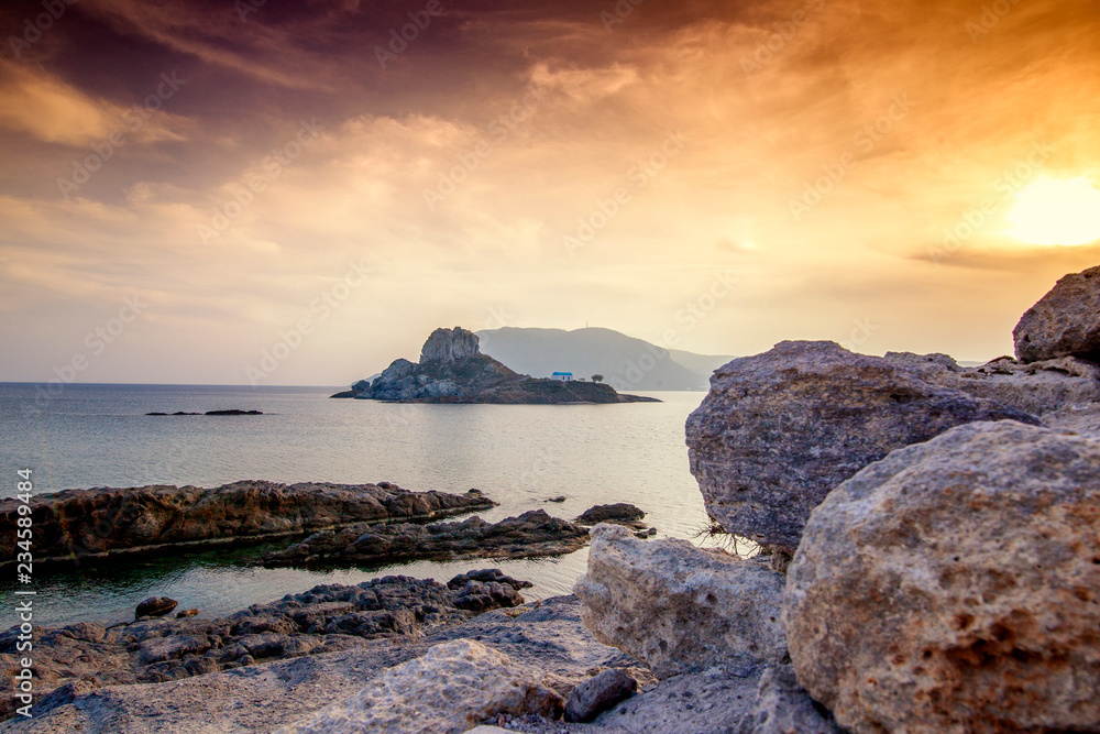 Kos island, Greece, coast view of Kefalos village, island of Kastri and an orthodox temple at sunset