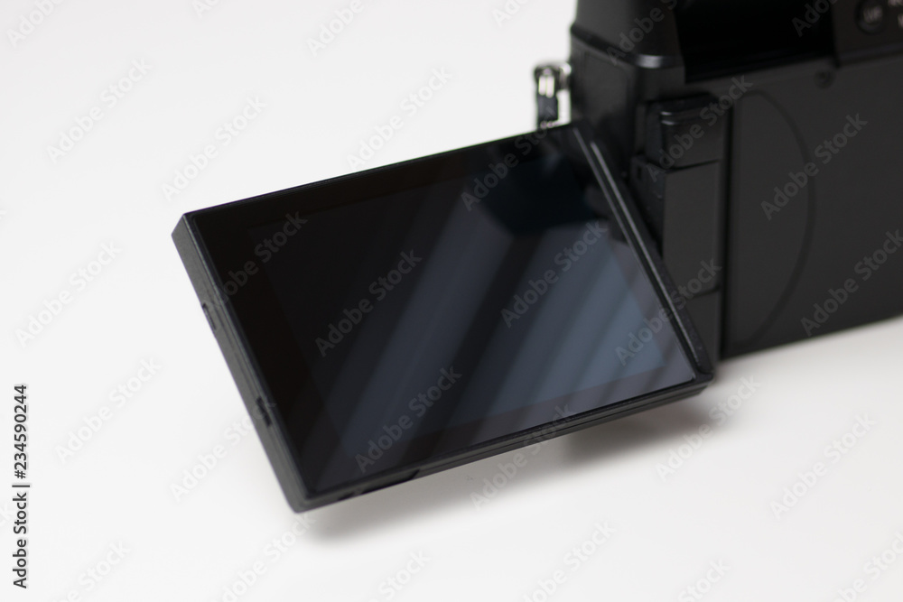 Flip out screen on a modern digital mirrorless camera isolated on white background. Flip out screen on a modern digital mirrorless camera isolated on white background.