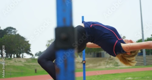Female athlete practicing high jump at sports venue 4k photo