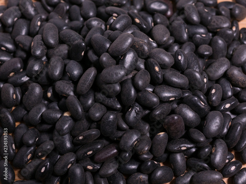 Raw uncooked black beans closeup macro detail view