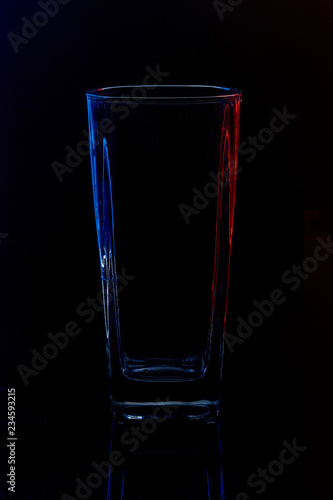Silhouette of a glass with water on a black background