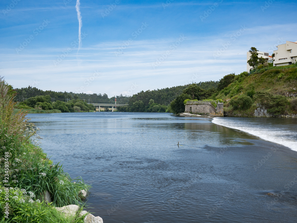 View across weir on Ave River in Vila do Conde, Porto region, Portugal View across weir on Ave River in Vila do Conde, Porto region, Portugal
