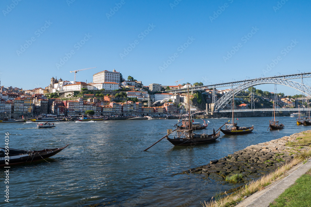 Cityscape of Porto, Portugal with traditional boats on River Douro