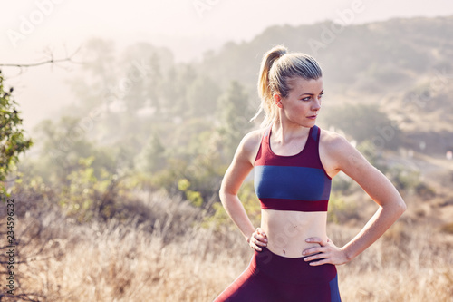 Beautiful Caucasian White Woman Takes A Break from Her Workout in the Morning Sunlight