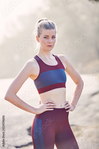 Beautiful Caucasian White Woman Takes A Break from Her Workout in the Morning Sunlight