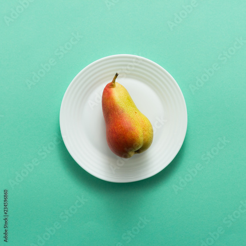 Ripe red yellow pear fruit on green background, top view, flat lay