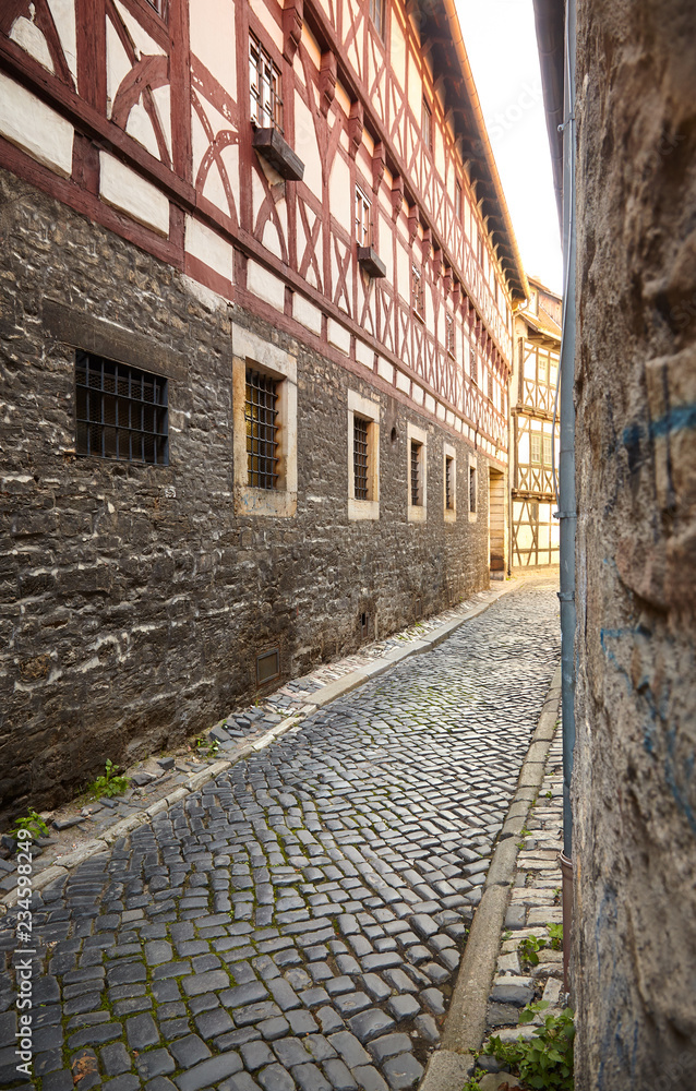 Narrow cobbled street between half-timbered houses in historical city center of Erfurt