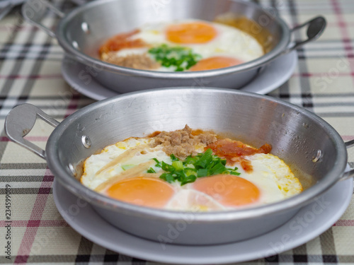 Breakfast with fried eggs in a pan.