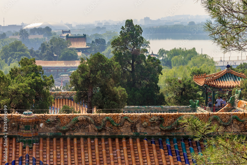 Fototapeta premium The temple roof and Beijing city skyline from the top of Buddhist Yong'An (Temple of Everlasting Peace) in Beihai Park, Beijing, China