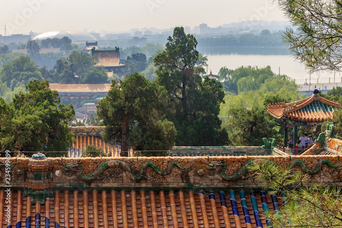 The temple roof and Beijing city skyline from the top of Buddhist Yong'An (Temple of Everlasting Peace) in Beihai Park, Beijing, China photo