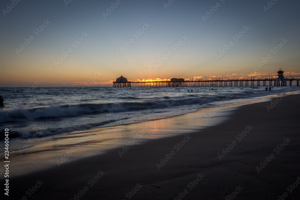 Distant Ocean Pier Against Sunset