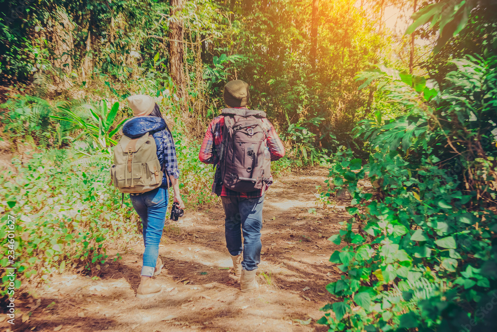 Young couple hiking tourist with backpack drinking water in nature. Young couple hiking tourist with backpack drinking water in nature.