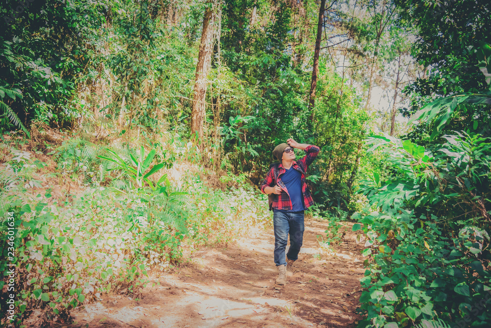 Young Man Traveler with map backpack relaxing outdoor with rocky mountains on background Summer vacations and Lifestyle hiking concept Young Man Traveler with map backpack relaxing outdoor with rocky mountains on background Summer vacations and Lifestyle hiking concept