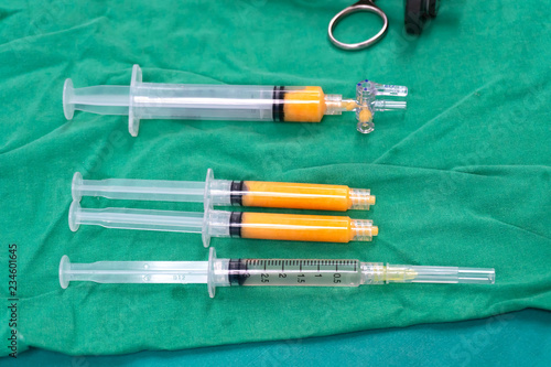 fat syringes for fat grafting on steriled green fabric