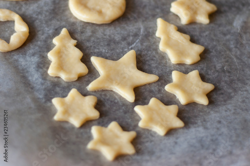 Cooking homemade Christmas cookies. Cutting out dough.