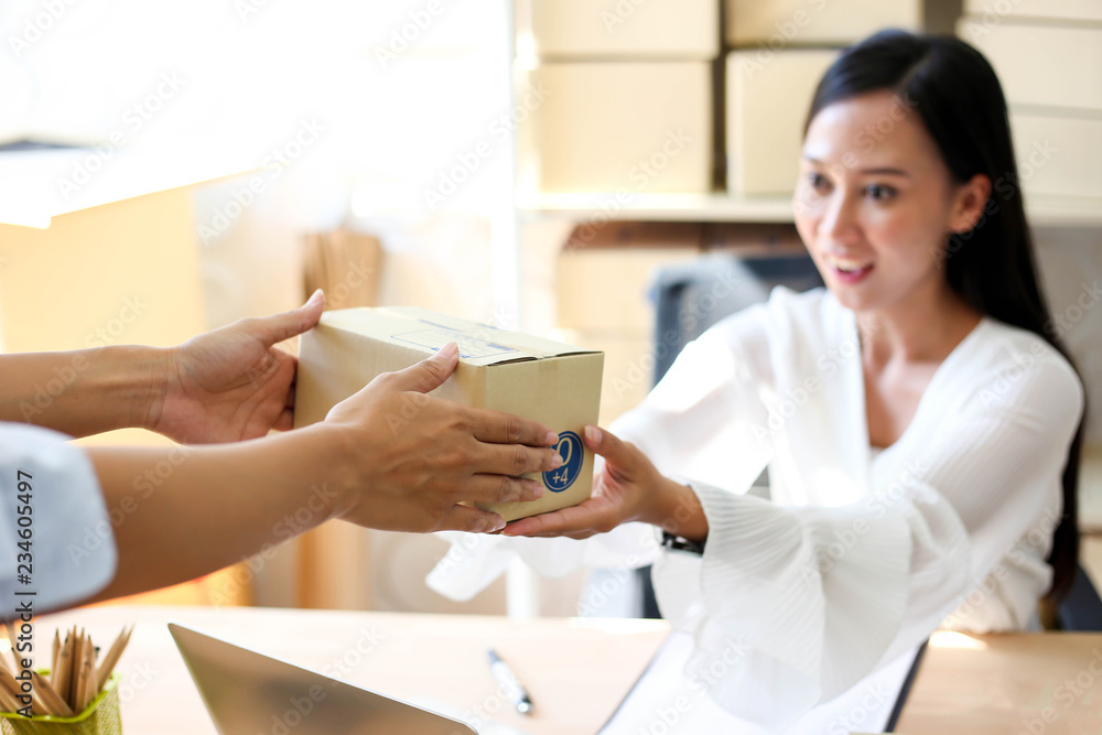 Young asian girl is freelancer Start up small business owner writing address on cardboard box at workplace,Shipping shopping online small business entrepreneur SME or freelance Young asian girl is freelancer Start up small business owner writing address on cardboard box at workplace,Shipping shopping online small business entrepreneur SME or freelance