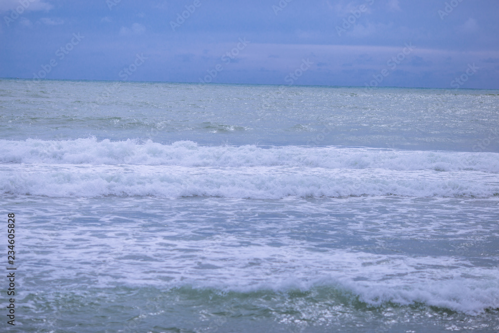 Wavy sea wallpapers crashing into the rocks on the beach, the intensity of sea breezes and storms during the season of nature.