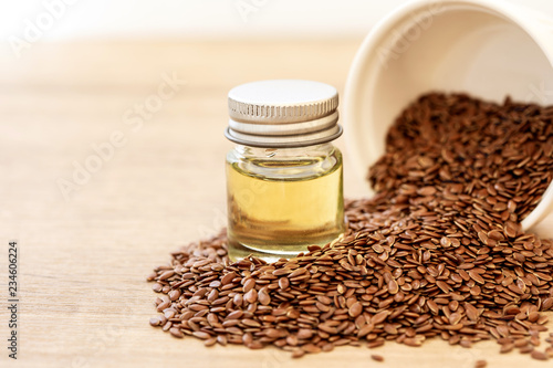 Close up a flaxseed  essential oil and seeds in wooden spoon , Heart healthy food  which superfood and rich of omega 3