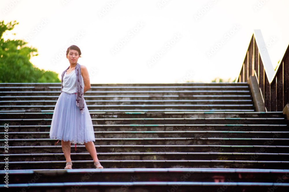 Asian female model poses for pictures in the cityscape Asian female model poses for pictures in the cityscape