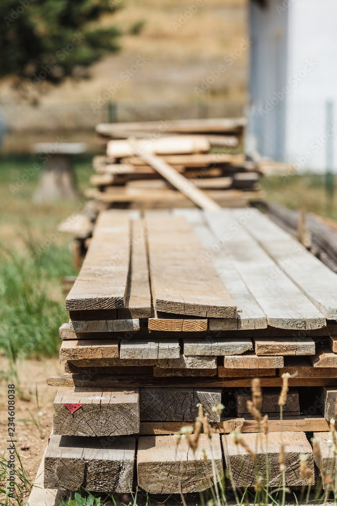 Fototapeta premium Stack of wooden piles plank boards