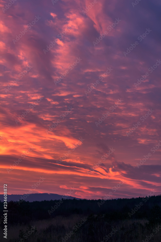 Amazing sunset red clouds in blue hour