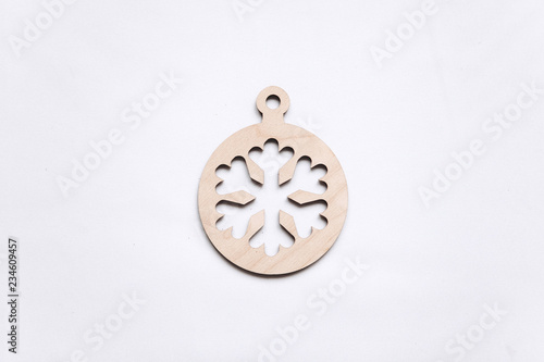 Christmas or New Year concept in minimal style - Christmas-tree decoration in the form of a snowflake on a white background. Minimalism.